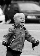 monochrome picture of happy child among city street