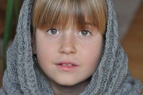 Girl in gray scarf on her head