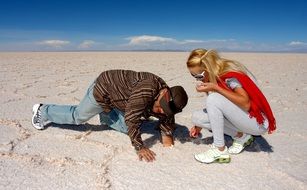 man and woman on a salt lake