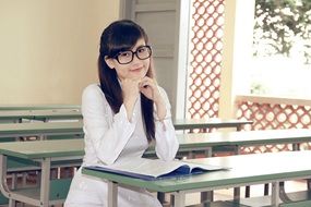 girl sitting at her desk at school