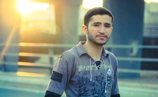 young man walking on road, iraq, baghdad
