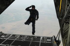 Man jumping from the plane to do skydiving