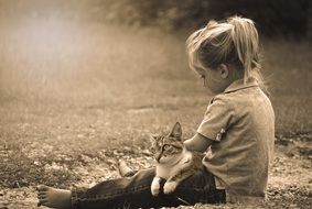 monochrome picture of child play with cat