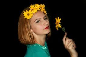 Portrait of a blonde girl with a yellow flower