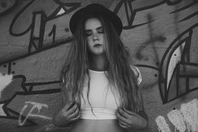 black and white photo of a beautiful girl in a hat