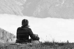 black and white photo of a girl with a teddy bear on a hill