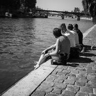 black and white photo of young people by the river
