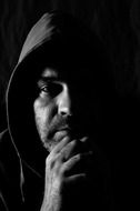 black and white portrait of a man in a hood