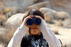 Child look out with binoculars
