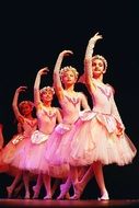 young ballerinas on stage in pink dresses