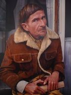 portrait of a man in a jacket near the wall