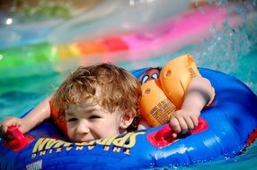 little boy on a colorful rubber ring