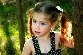 Beautiful blue eyed baby girl with curly blond hair