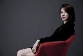 pensive woman in a red chair