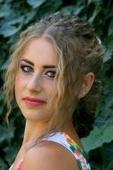 portrait of a girl with blue eyes on a green background