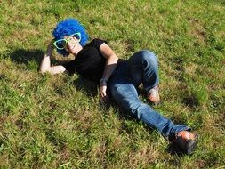 funny man with big glasses and a blue wig on his head