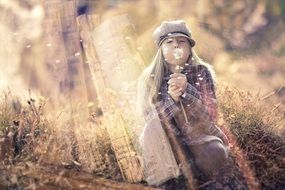 picture of the girl is blowing a dandelion