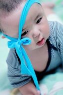 little boy with a blue bow