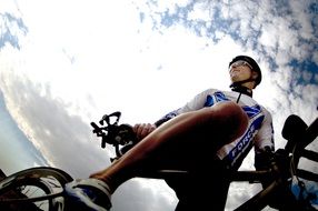 bottom view of a cyclist against the sky