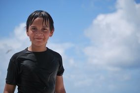 child on the beach against the sky