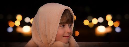 little girl with a scarf on her head