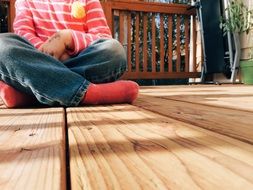 child sitting on the wooden floor