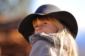 little girl in a black hat