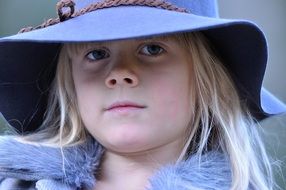 Portrait of blonde girl in a hat