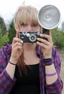 portrait of the girl is holding a camera