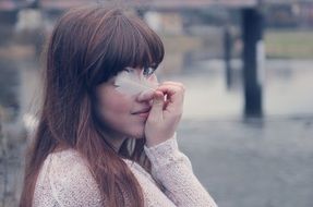 portrait of a girl with a bird feather in hands