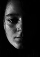 half of girl's face in shadow