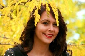 portrait of a girl on a background of autumn yellow leaves