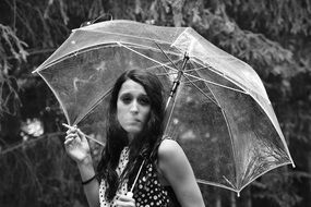 smoking girl with umbrella in black and white image