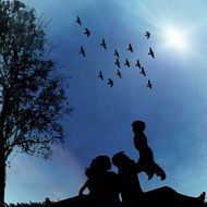 silhouettes of family and flying birds