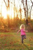 Landscape of girl running in a autumnal forest