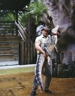 wrestler at performance, man holding alligator