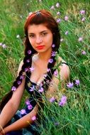 girl is sitting in a flower field