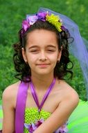 girl's hair decorated with colored flowers