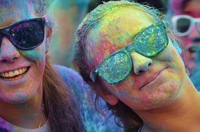 girls in paint of different colors at the festival
