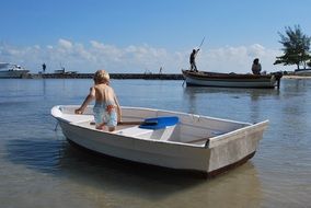 view from the back your child alone in a boat