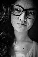 black white portrait of a girl with glasses