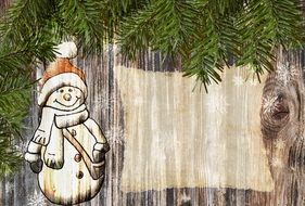 drawing of a snowman on a wooden board as a greeting card