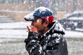 Mongolian man with a cigarette in winter