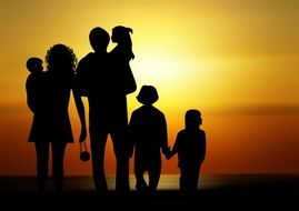 silhouette of a family against the orange sky at sunset
