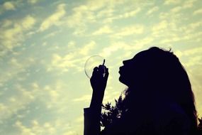 silhouette of a girl with soap bubbles