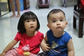 cute babies sitting on the floor