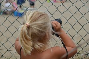 girl with blond hair and a camera