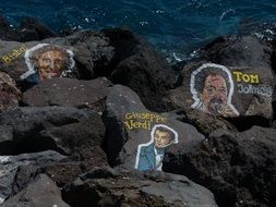 image of musicians on stones on the ocean on Tenerife