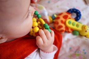 baby nibbles a toy