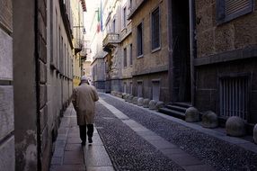 man walking down the street in italy